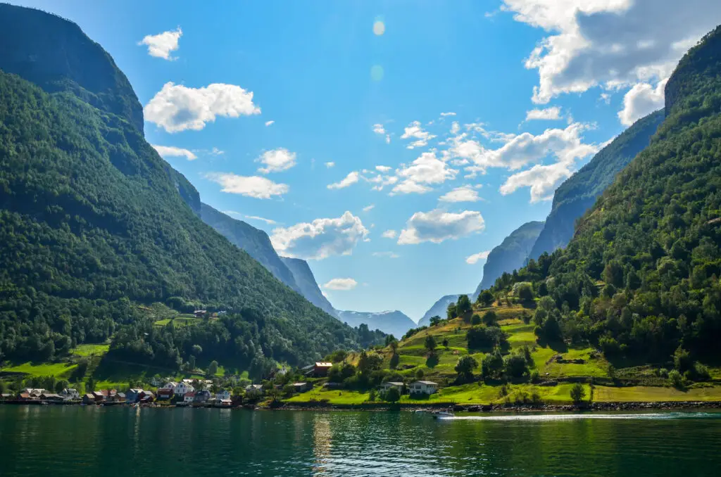 Scenic view of the serene Undredal village beside Aurlandsfjord with lush green mountains in Flam, Norway, perfect for a peaceful getaway.