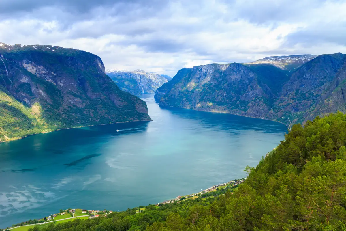 Breathtaking view of the serene blue waters and majestic fjords at Stegastein viewpoint in Norway, showcasing the natural beauty of Scandinavian landscapes.