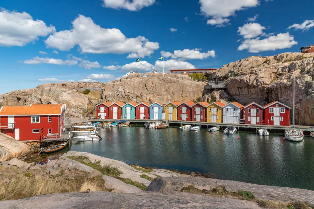 Colorful traditional seaside boathouses in Smögen, Sweden, showcasing Swedish boating culture and the unique rocky landscape of the Schären archipelago.