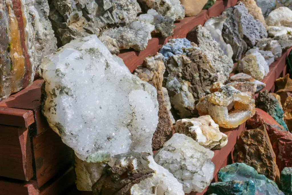 Collection of colorful natural stones and minerals displayed in Iceland, showcasing geological diversity ideal for tourism and educational purposes.