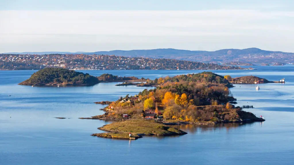 Panoramic view of Bleikoya island in the Oslo Fjord, Norway, showcasing vibrant autumn colors and serene waters, ideal for Scandinavian tourism and nature exploration.