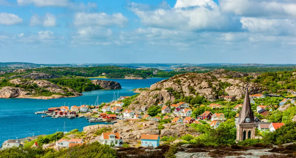 Panoramic view of Fjällbacka in Västergötland, Sweden, showcasing the coastal village, colorful houses, and rocky landscape.