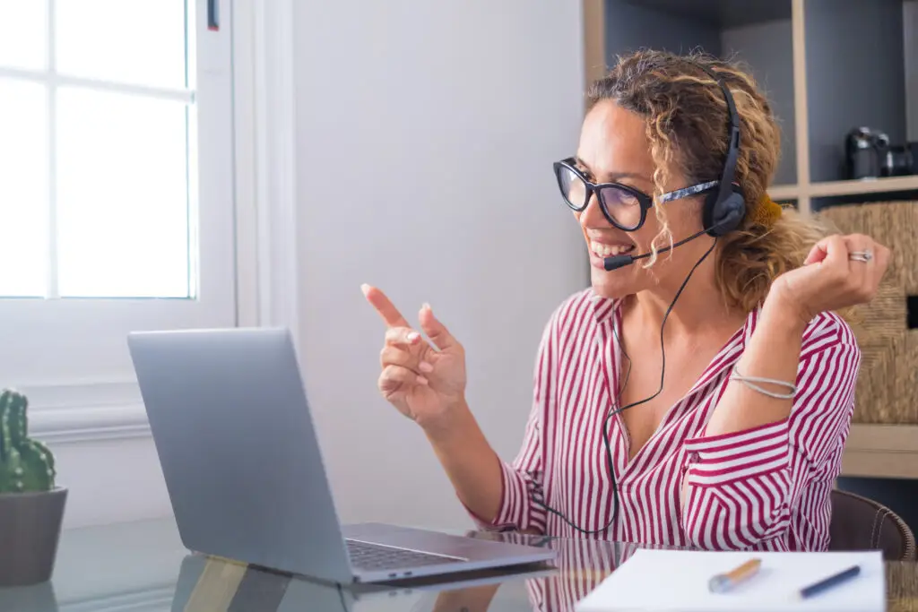 Attractive caucasian woman working as a virtual tour guide for Scandinavia Private Tours, engaging with clients from her home office