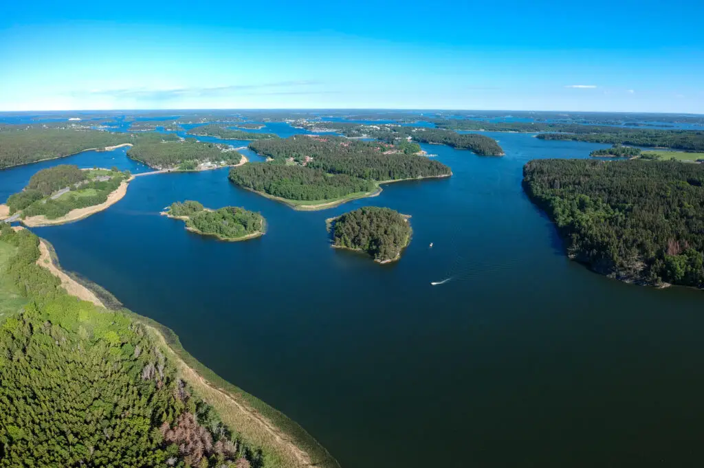 Aerial view of the scenic Stockholm archipelago in Sweden showing lush green islands surrounded by vibrant blue waters