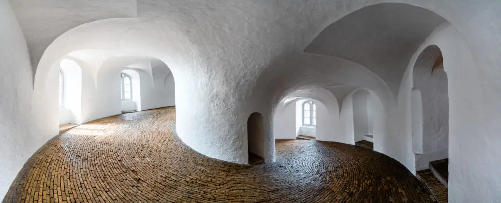 Interior panorama of Round Tower (Rundetaarn) in Copenhagen, Denmark, showing the unique 17th-century brick spiral ramp and white arches