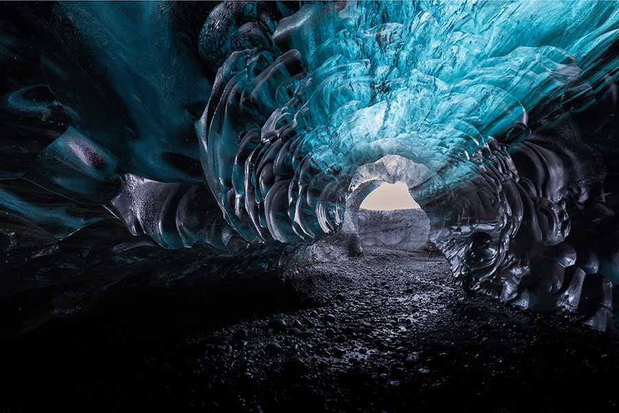 Breathtaking interior view of the blue ice cave in Vatnajokull glacier, Iceland, showcasing the natural icy textures and light play within