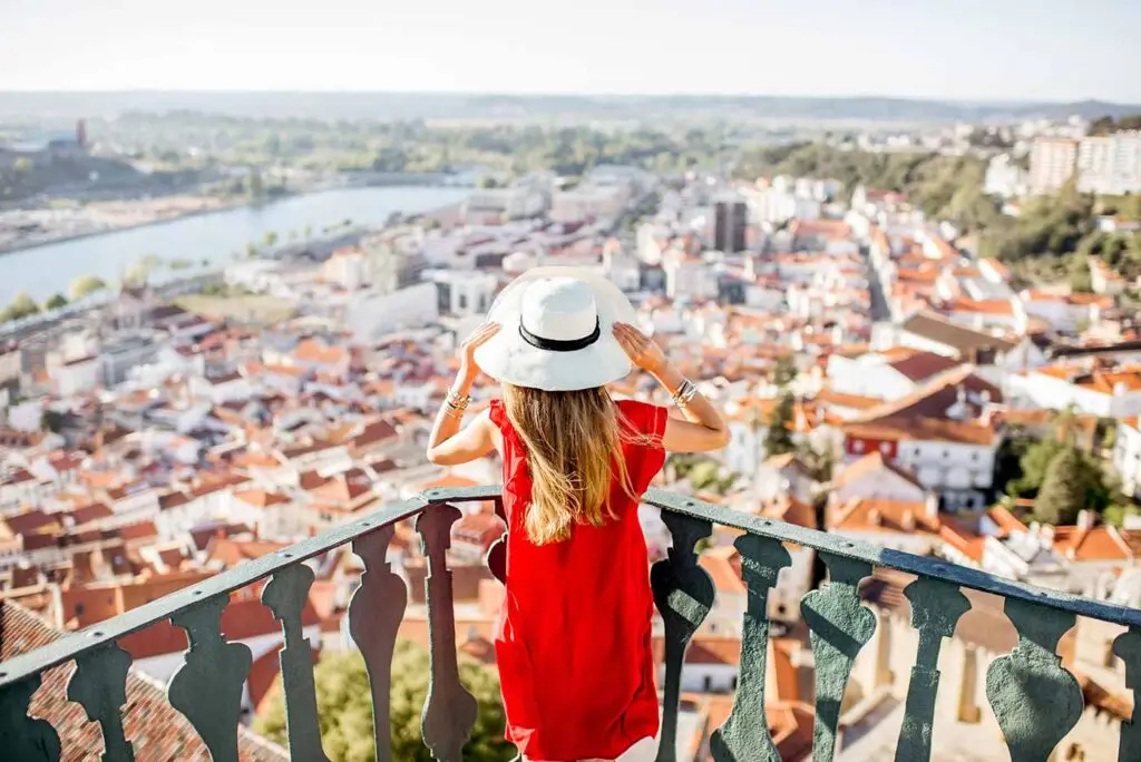 Tourist at Coimbra City Viewpoint overlooking the scenic urban landscape and river in Portugal