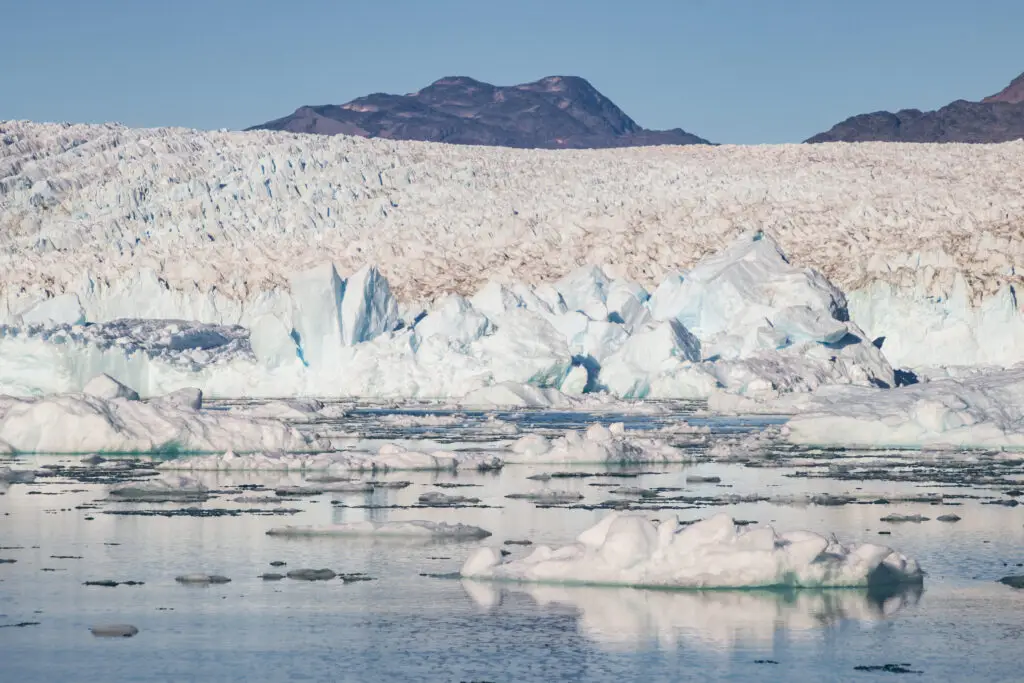 Breathtaking view of Qooqqut Fjord with Qooqqup Glacier and floating icebergs in South Greenland, highlighting stunning natural Arctic scenery.