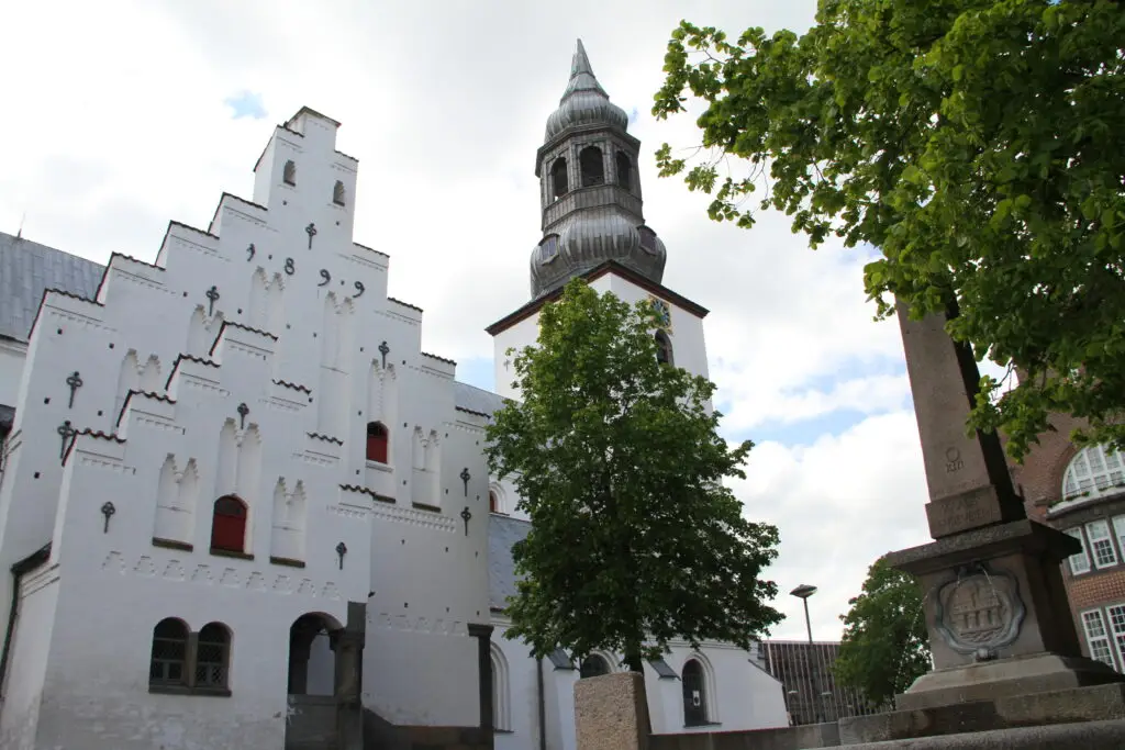 Historic Budolfi Cathedral and Jens Bang's Stonehouse in Aalborg, Denmark, showcasing Danish architecture and heritage.