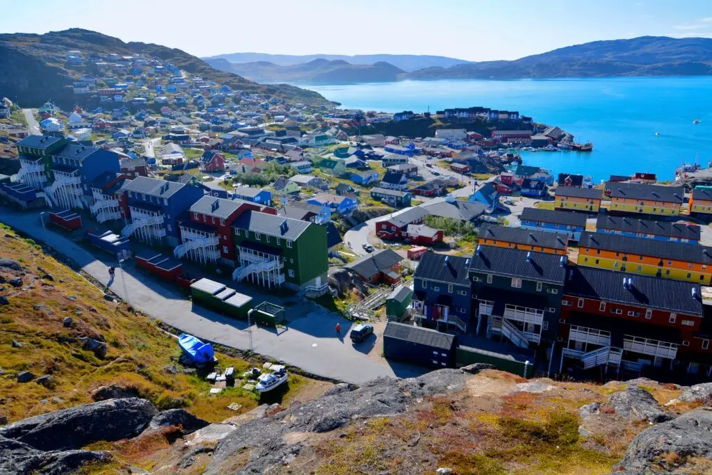Colorful houses and rugged terrain in Qaqortoq, Greenland, showcasing a typical scenic village in Scandinavia.