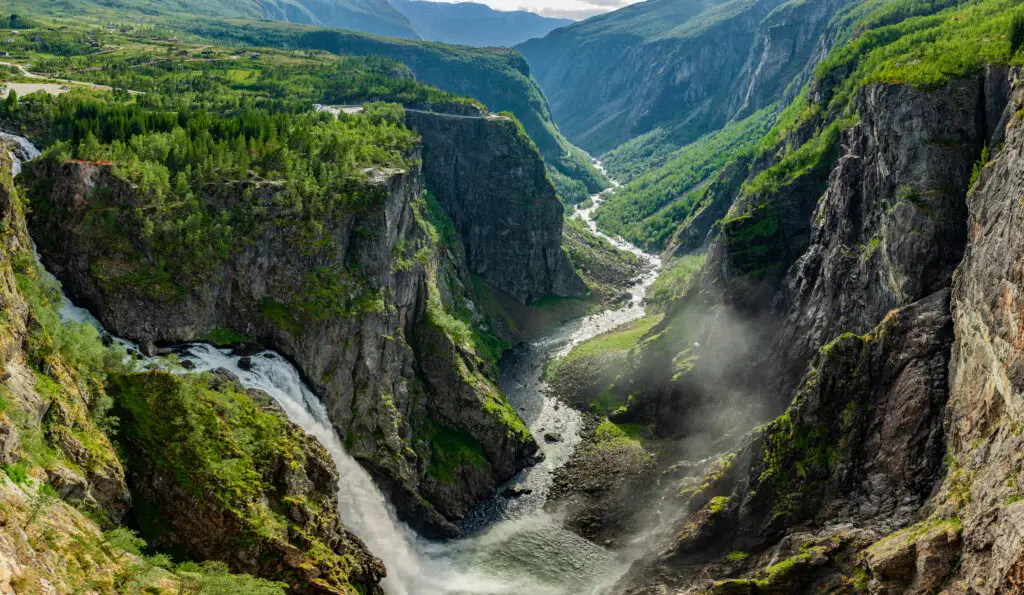 Vøringsfossen waterfall in Måbodålen, Norway showcasing a spectacular panoramic view of cascading waters and rugged cliffs surrounded by lush greenery.