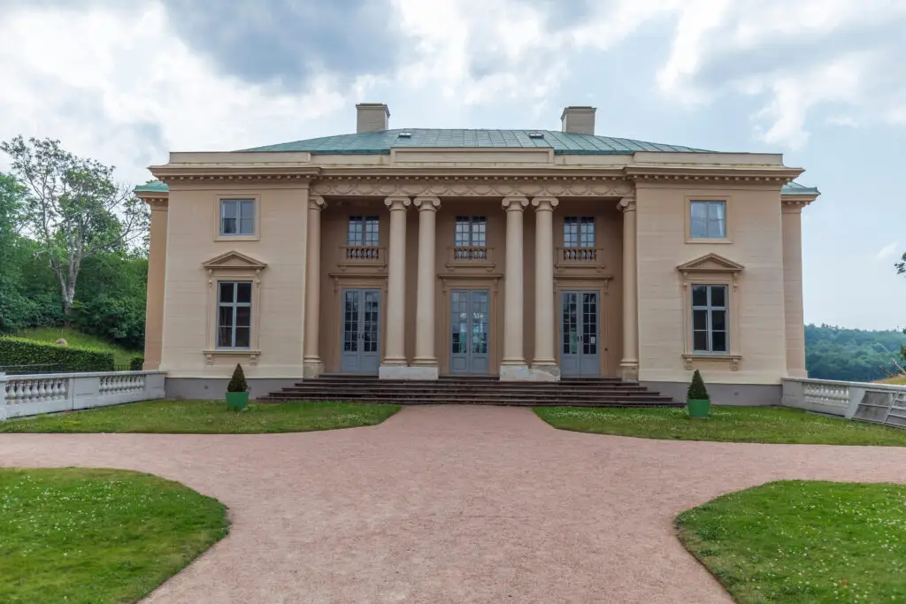 Front view of Gunnebo Palace in Mölndal, Sweden, showcasing its neoclassical architecture with grand columns and manicured lawns, perfect for historical tours and cultural visits.