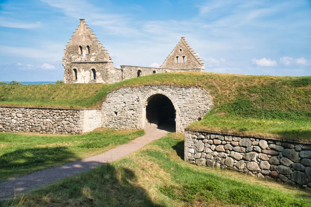 Historic Visingsborg Castle ruins on Visingsö, Sweden, showcasing ancient stone architecture against a clear blue sky, located in Lake Vättern.